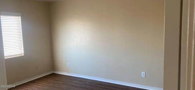 a view of an empty room and wooden floor