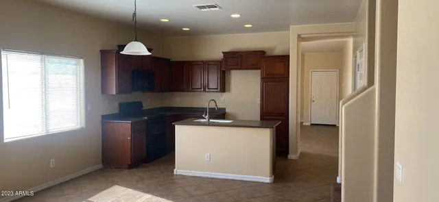 a kitchen with stainless steel appliances granite countertop a refrigerator a sink and a stove