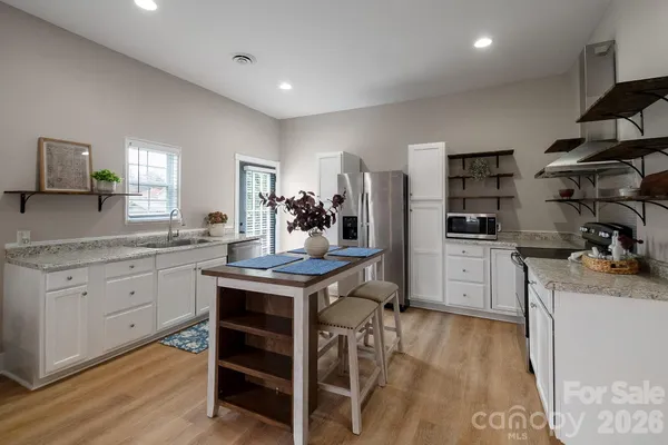 a kitchen with stainless steel appliances a stove and cabinets