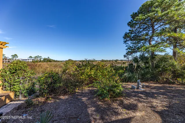 a living room with furniture kitchen view and a window