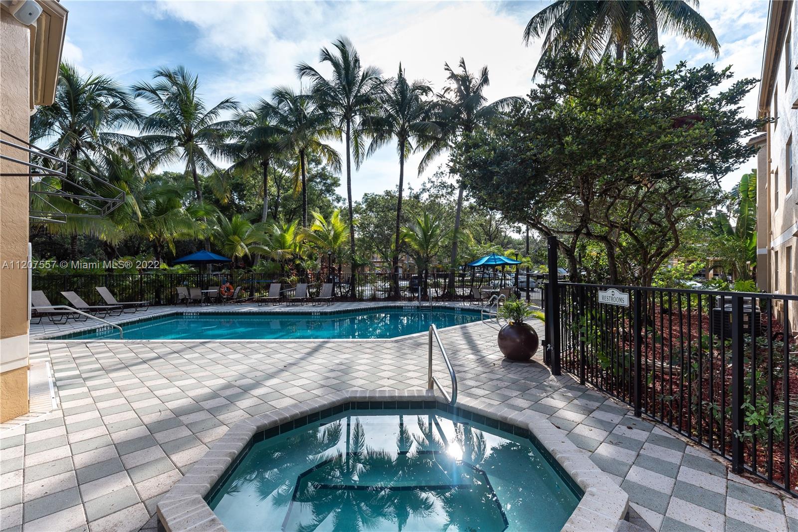 771 North Pine Island Road, Unit 203 Plantation, FL 33324 - Photo 18 of 20 a swimming pool with outdoor seating and trees
