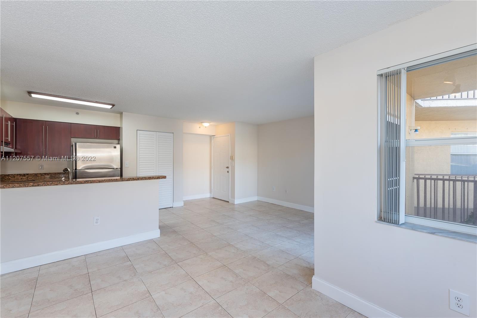 771 North Pine Island Road, Unit 203 Plantation, FL 33324 - Photo 3 of 20 a view of a kitchen from the hallway