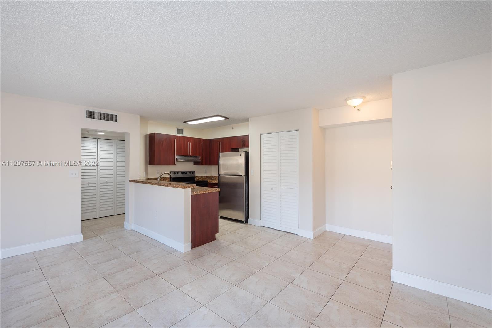 771 North Pine Island Road, Unit 203 Plantation, FL 33324 - Photo 4 of 20 a kitchen with stainless steel appliances granite countertop a refrigerator and a sink