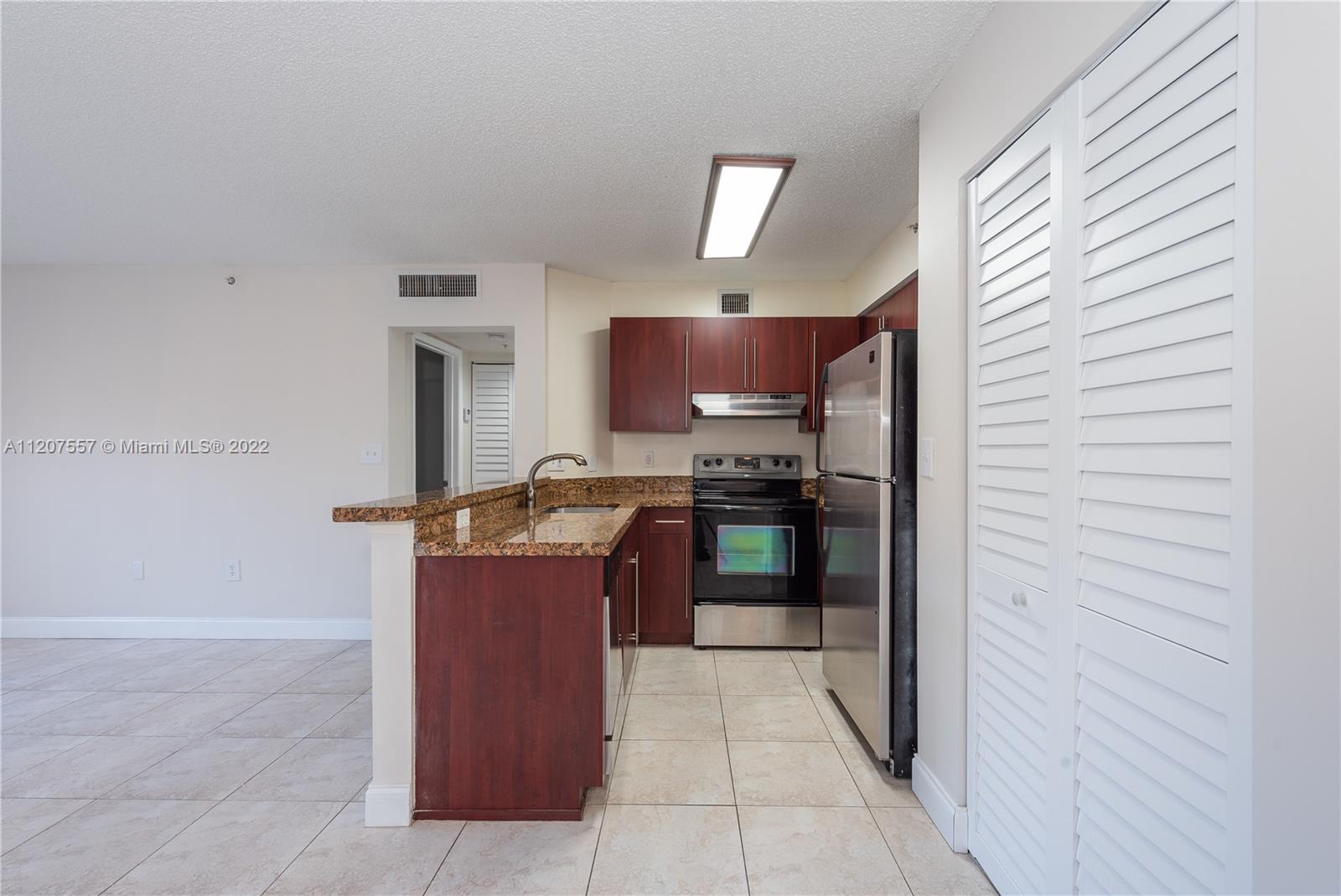 771 North Pine Island Road, Unit 203 Plantation, FL 33324 - Photo 6 of 20 a kitchen with a refrigerator and a stove