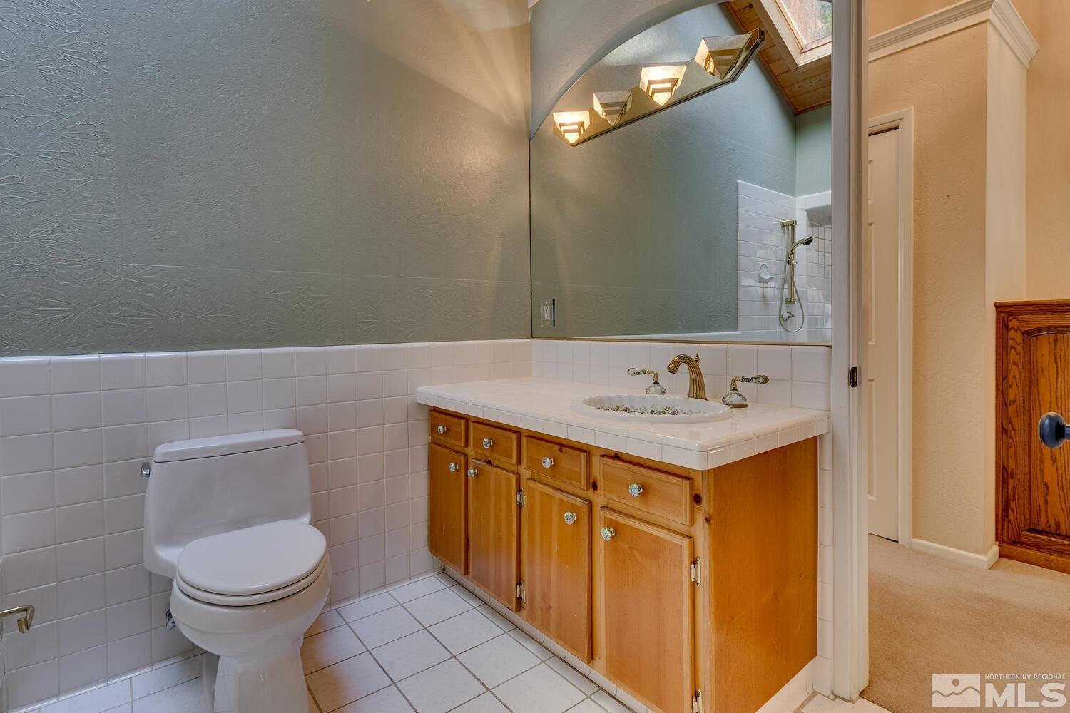 308 Elks Point Road Zephyr Cove, NV 89448 - Photo 19 of 29 a bathroom with a sink a toilet and mirror