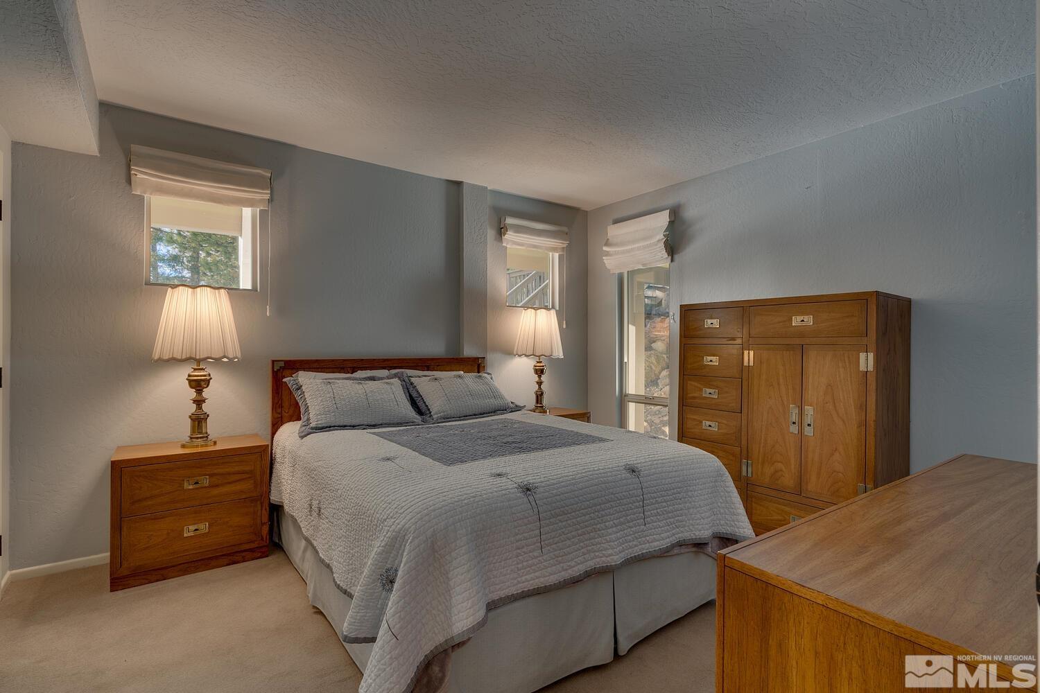 308 Elks Point Road Zephyr Cove, NV 89448 - Photo 24 of 29 a bedroom with a bed and a lamp