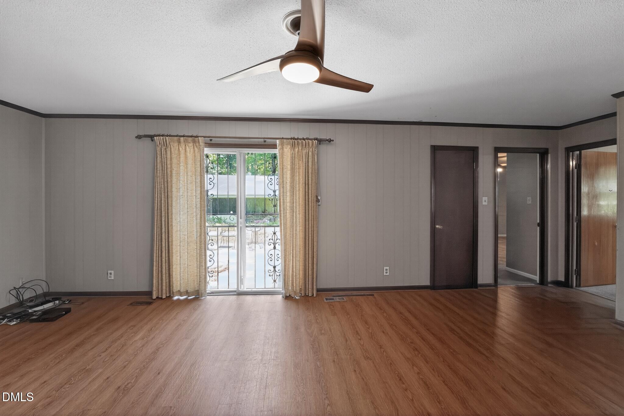 1034 Jerome Road Durham, NC 27713 - Photo 11 of 35 a view of an empty room with wooden floor and a window