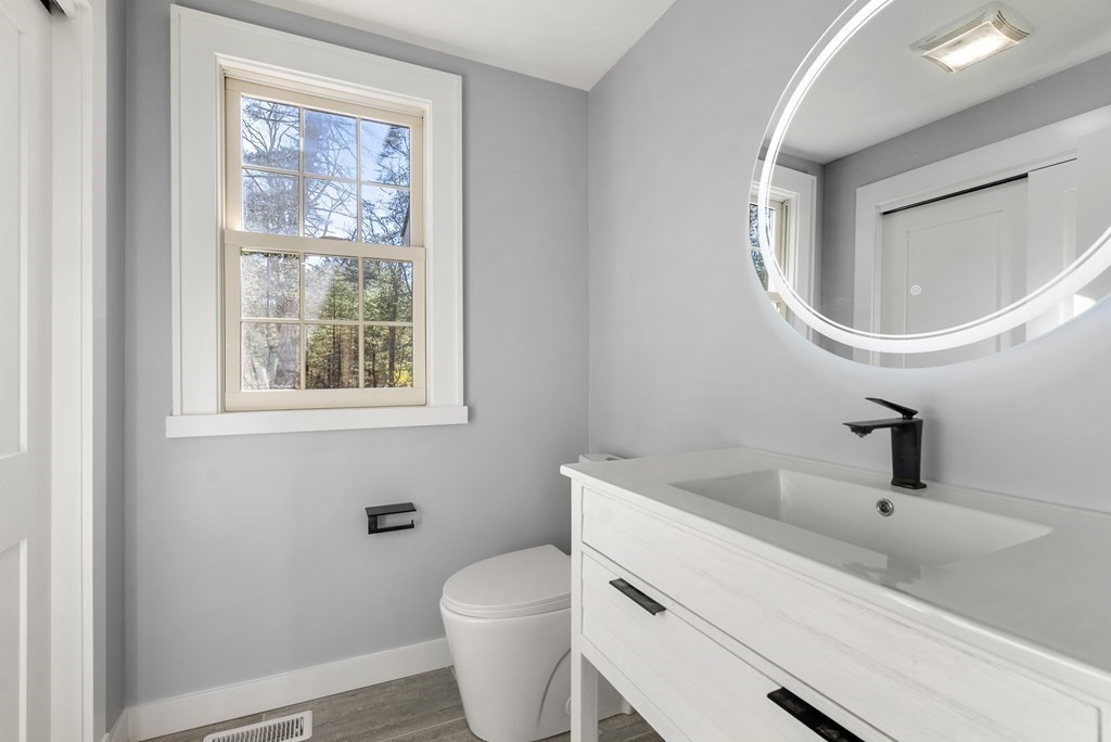 162 Winter Street Weston, MA 02493 - Photo 18 of 36 a bathroom with a toilet a sink and mirror