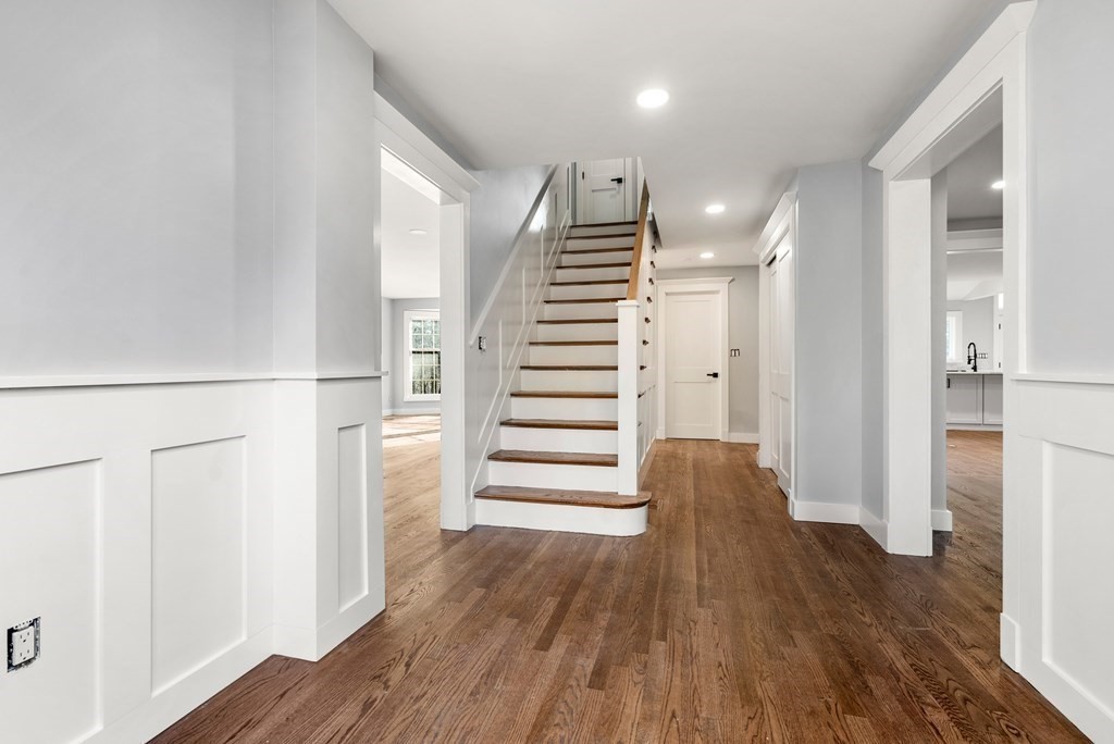 162 Winter Street Weston, MA 02493 - Photo 19 of 36 a view of a hallway with wooden floor and stairs