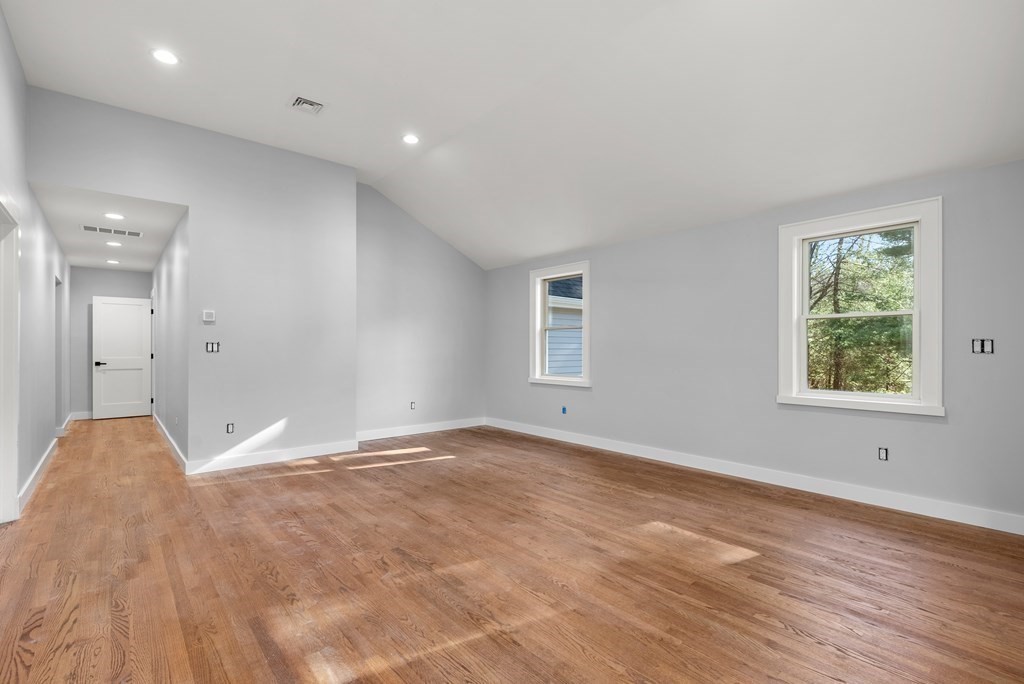 162 Winter Street Weston, MA 02493 - Photo 20 of 36 a view of an empty room with wooden floor and a window