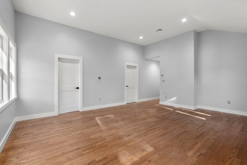 162 Winter Street Weston, MA 02493 - Photo 21 of 36 a view of an empty room with wooden floor and a window