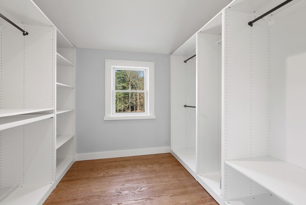 162 Winter Street Weston, MA 02493 - Photo 22 of 36 a view of an empty room with wooden floor and a window