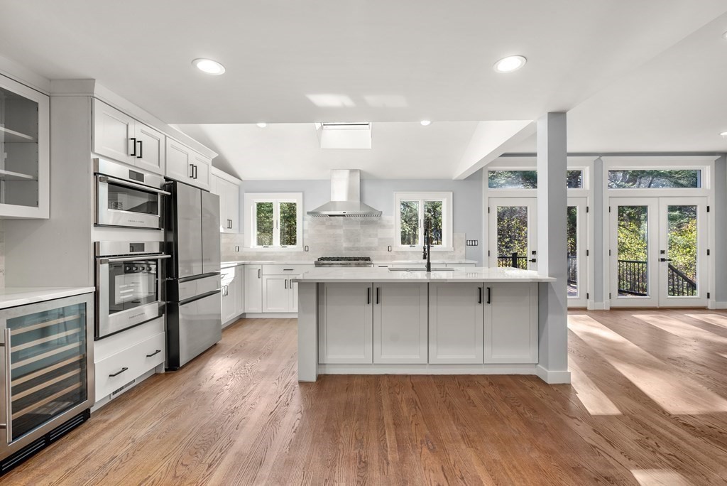 162 Winter Street Weston, MA 02493 - Photo 3 of 36 a kitchen with stainless steel appliances a sink cabinets and wooden floor