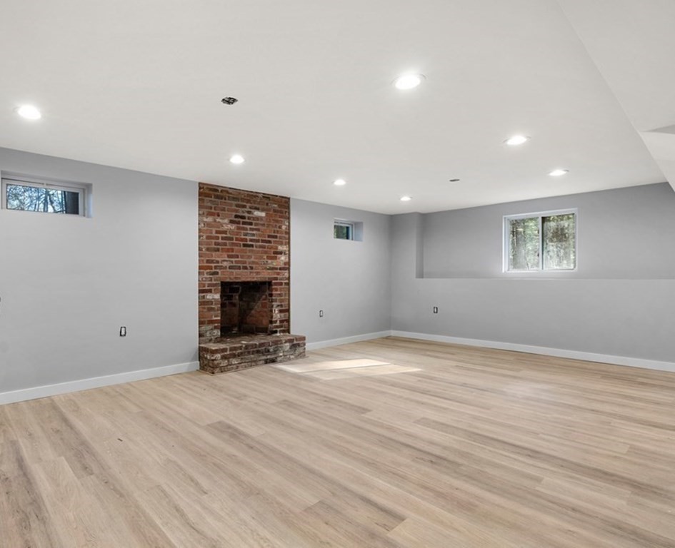 162 Winter Street Weston, MA 02493 - Photo 31 of 36 a view of an empty room with wooden floor and a fireplace
