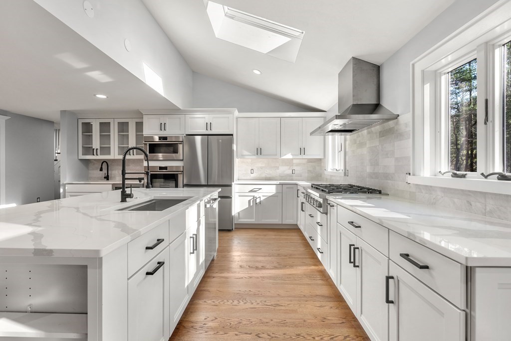 162 Winter Street Weston, MA 02493 - Photo 7 of 36 a large kitchen with stainless steel appliances lots of counter space and a sink