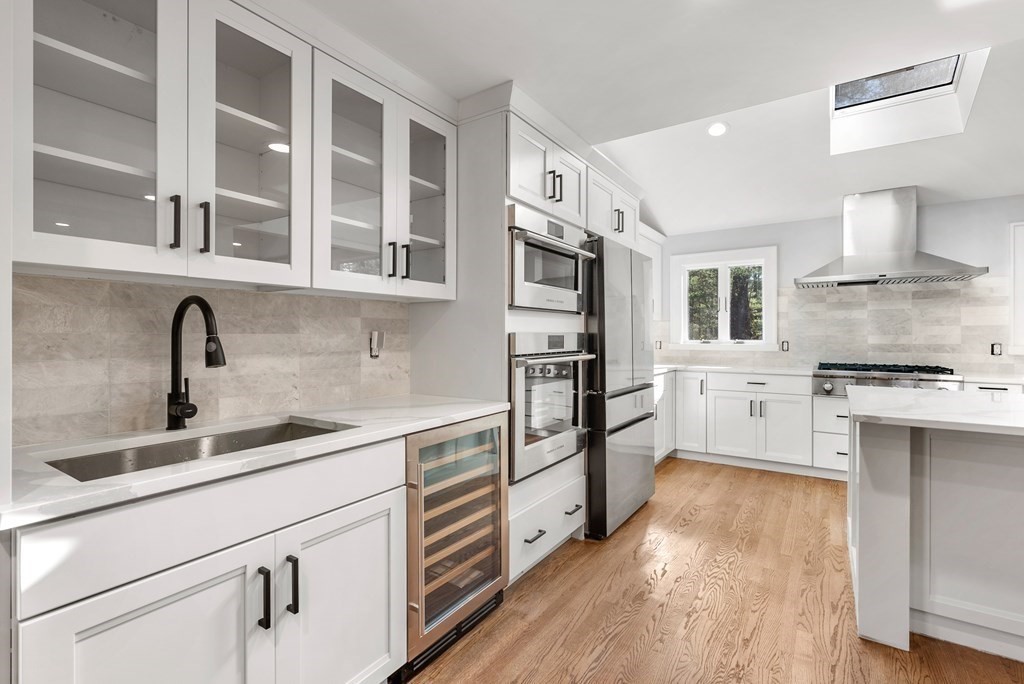 162 Winter Street Weston, MA 02493 - Photo 8 of 36 a kitchen with stainless steel appliances a sink cabinets and wooden floor