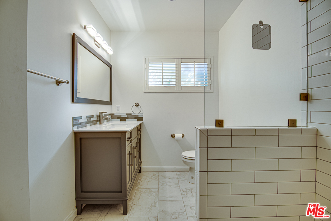 8204 Pershing Drive Playa del Rey, CA 90293 - Photo 24 of 27 a bathroom with a sink a toilet and mirror