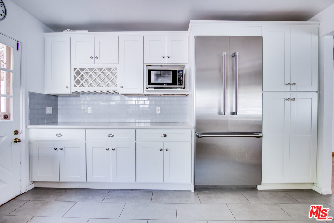 8204 Pershing Drive Playa del Rey, CA 90293 - Photo 8 of 27 a kitchen with white cabinets and refrigerator