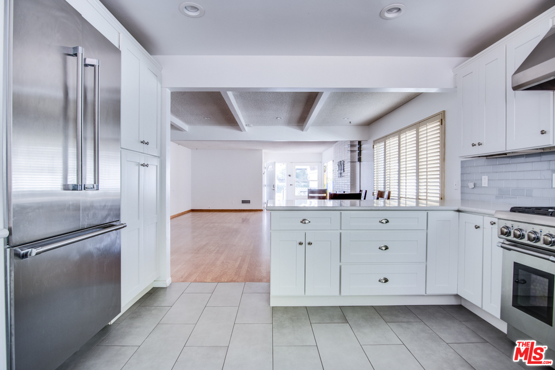 8204 Pershing Drive Playa del Rey, CA 90293 - Photo 9 of 27 a kitchen with white cabinets stainless steel appliances and a window
