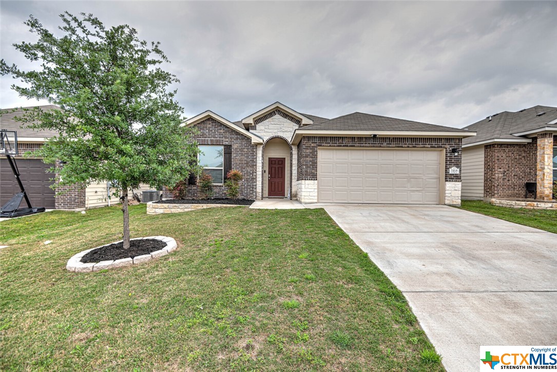 a front view of a house with a yard garage and outdoor seating