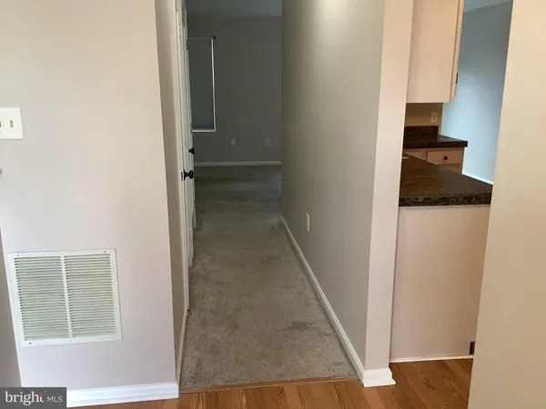 a kitchen with granite countertop a refrigerator and a stove top oven