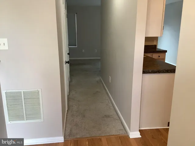 a kitchen with granite countertop a refrigerator and a stove top oven