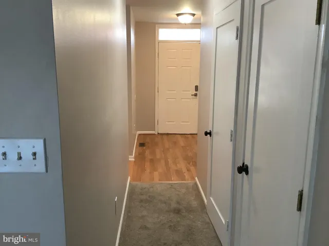 a kitchen with granite countertop cabinets and wooden floor