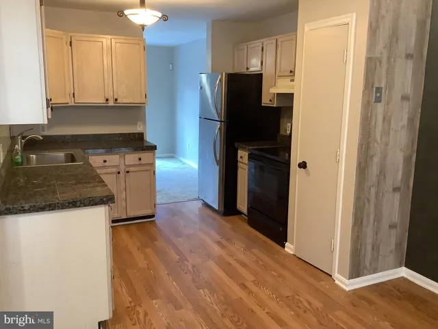 a view of a kitchen from the hallway