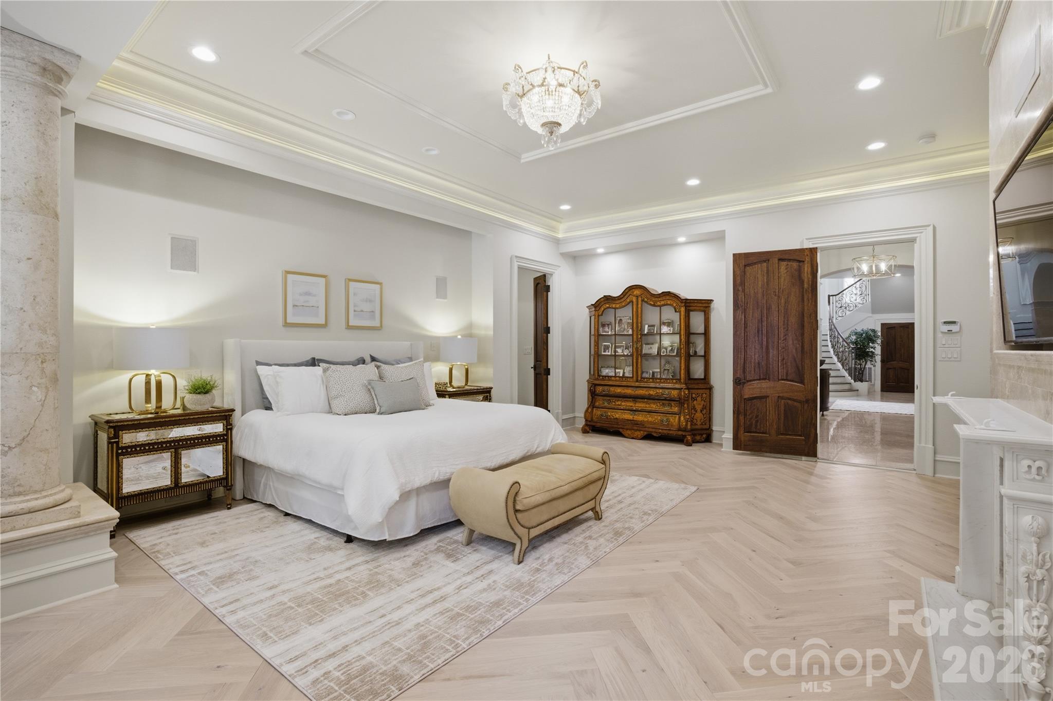 16460 Marvin Road Charlotte, NC 28277 - Photo 22 of 47 a spacious bedroom with a large bed and a chandelier