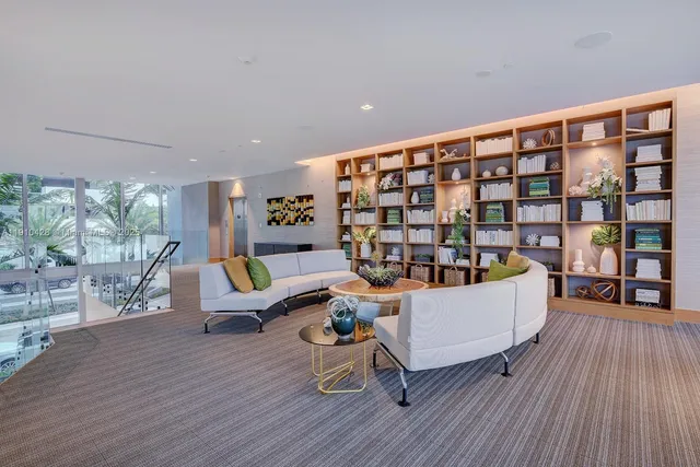 a living room with furniture floor to ceiling window and wooden floor