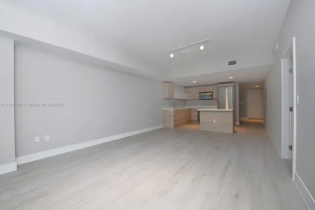 a view of a kitchen with white cabinets