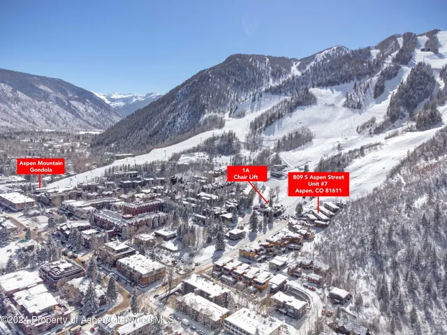 a view of a dry yard with mountains in the background