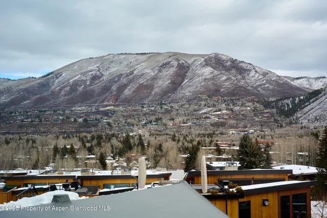 a living room with furniture a large window with wooden floor