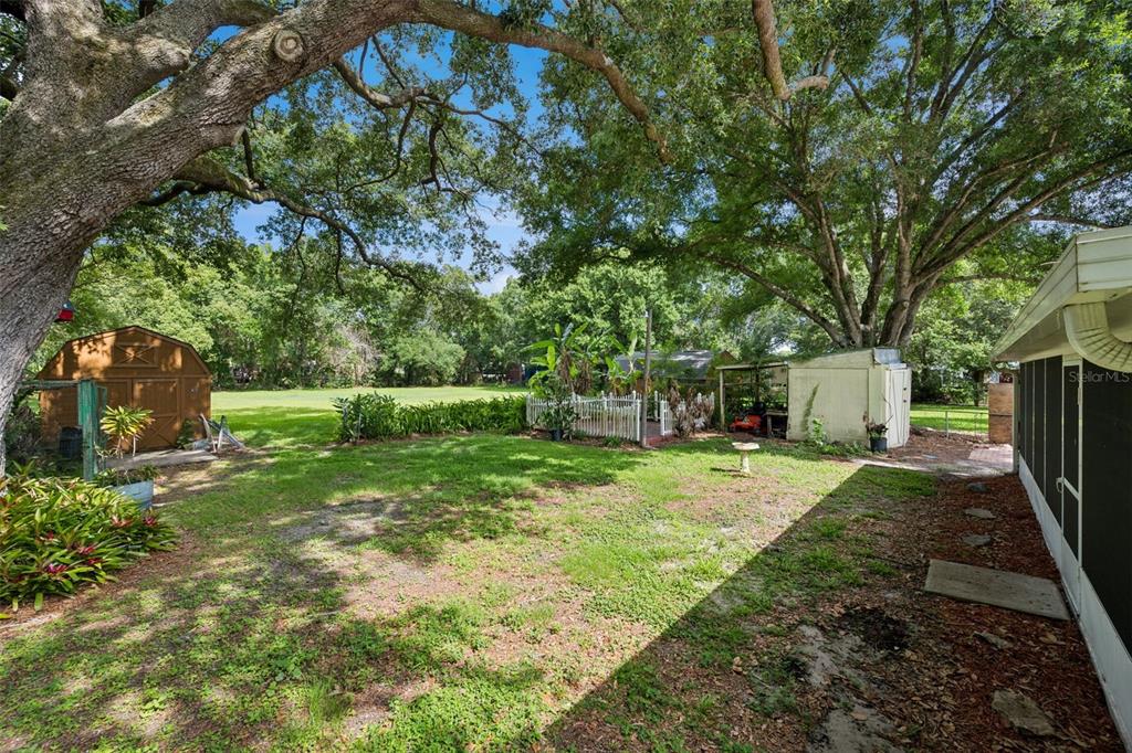 420 Jacks Memorial Road St. Cloud, FL 34769 - Photo 20 of 31 a backyard of a house with barbeque oven table and chairs
