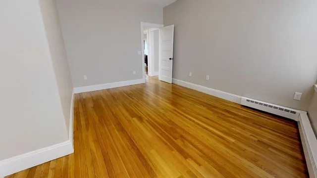 a view of room with wooden floor