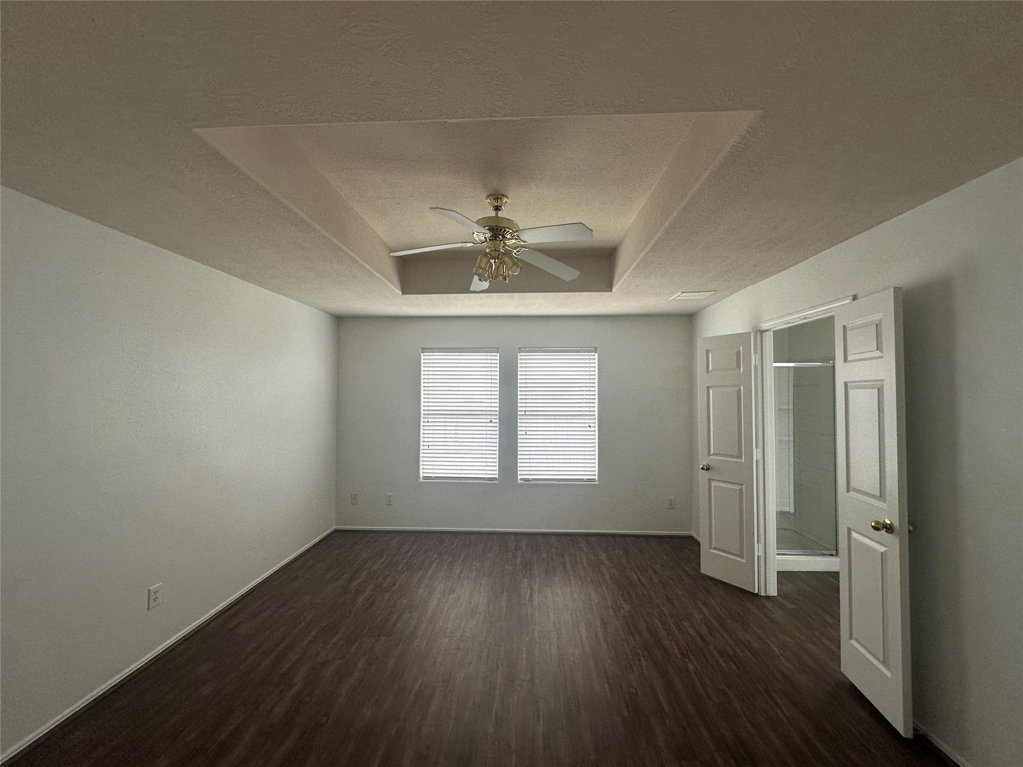 10331 Ravenwood View Lane Houston, TX 77075 - Photo 5 of 11 an empty room with wooden floor and windows