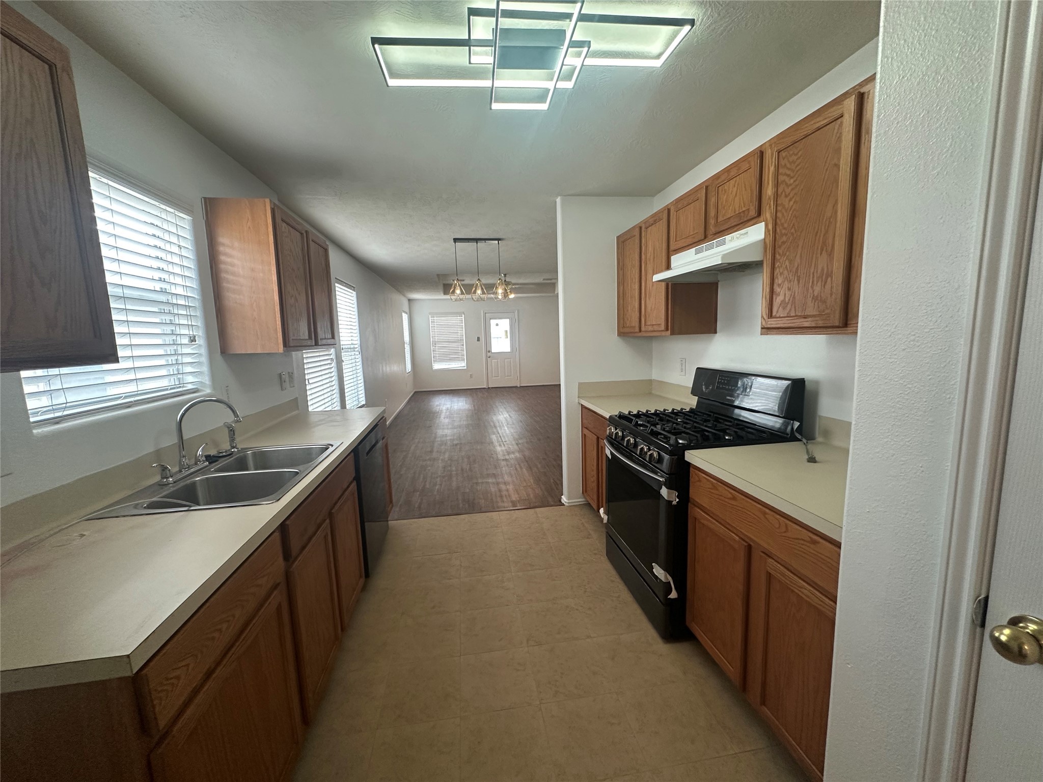 10331 Ravenwood View Lane Houston, TX 77075 - Photo 10 of 11 a kitchen with a sink stove and microwave
