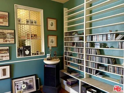 a living room with furniture fireplace and a large window