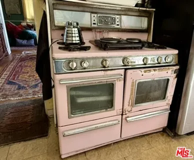 a bedroom with a bed window and a flat screen tv