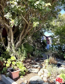 a backyard of a house with outdoor seating