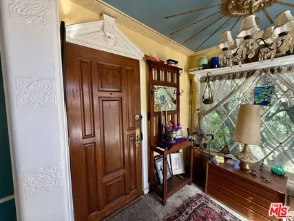 a outdoor living room with furniture and a floor to ceiling window