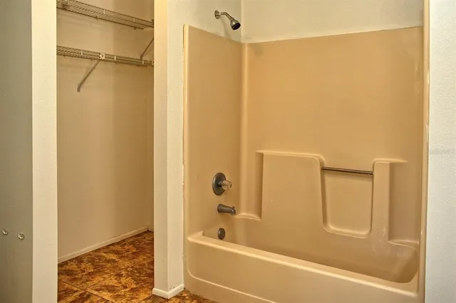 a bathroom with a bathtub and a shower