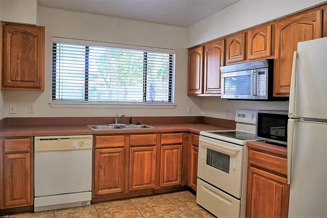 a kitchen with stainless steel appliances granite countertop a sink and cabinets