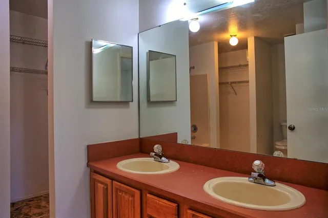a bathroom with a double vanity sink and a mirror