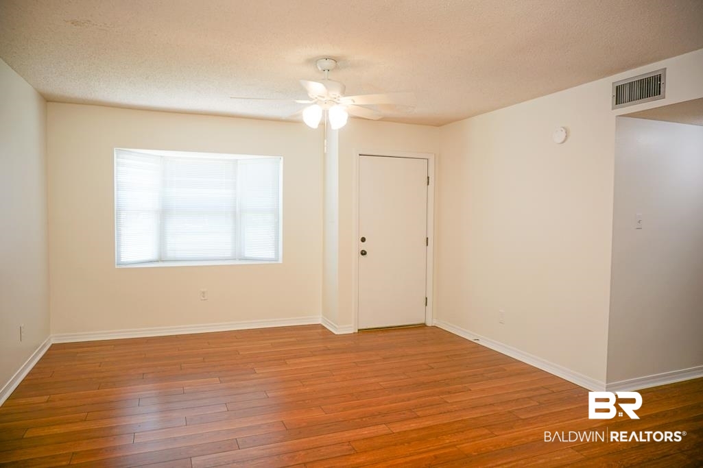 4377 Fathbrook Lane Mobile, AL 36693 - Photo 3 of 19 Empty room with baseboards, visible vents, wood finished floors, and ceiling fan