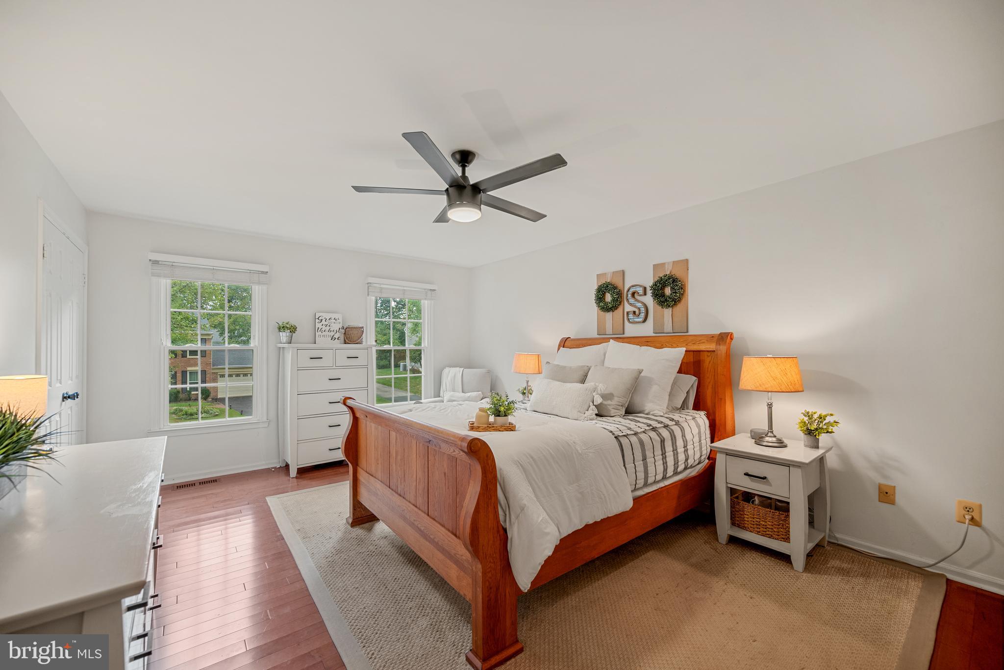 7838 Roundabout Way Springfield, VA 22153 - Photo 23 of 56 a bedroom with a large bed and a chandelier