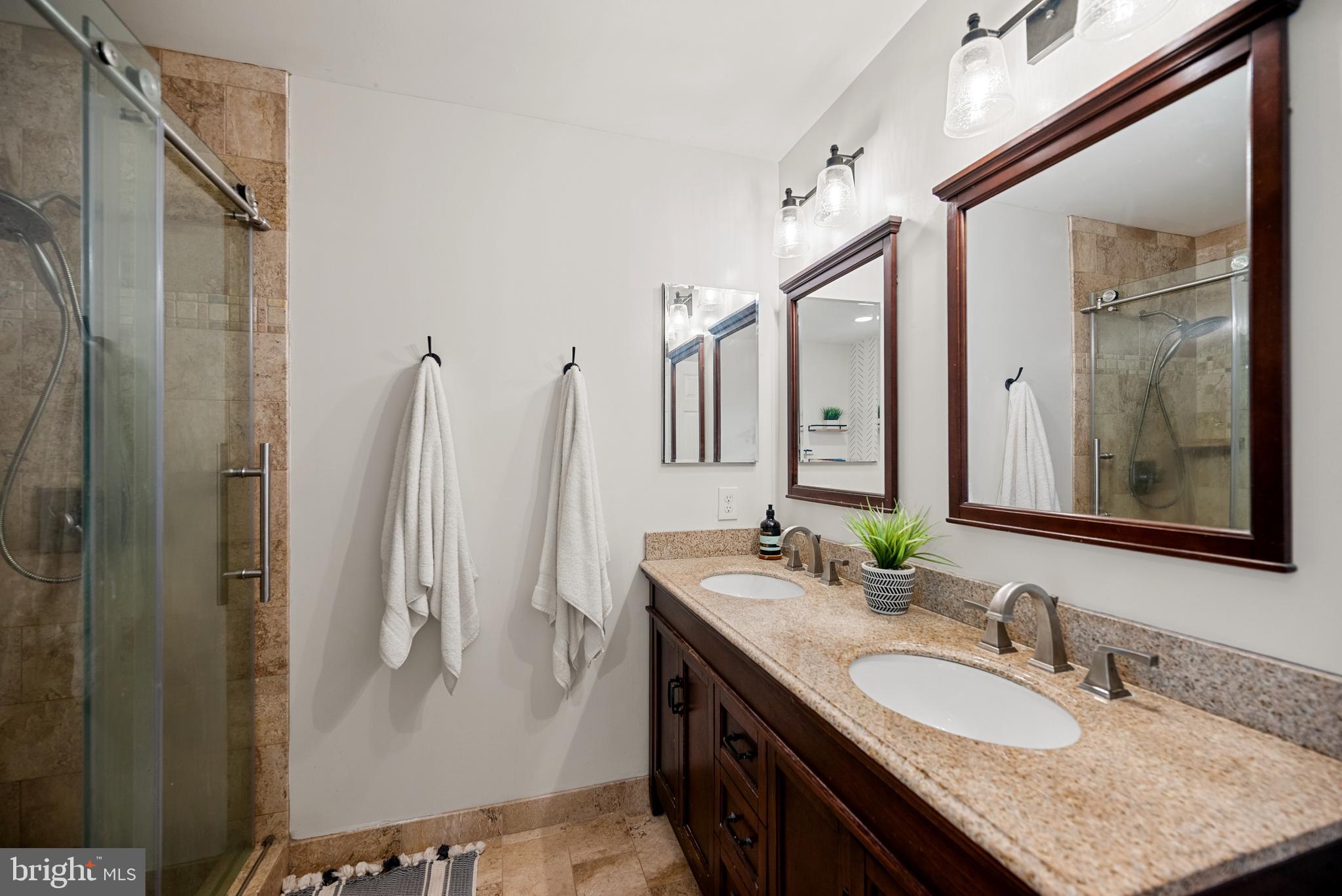7838 Roundabout Way Springfield, VA 22153 - Photo 25 of 56 a bathroom with a granite countertop sink and a mirror