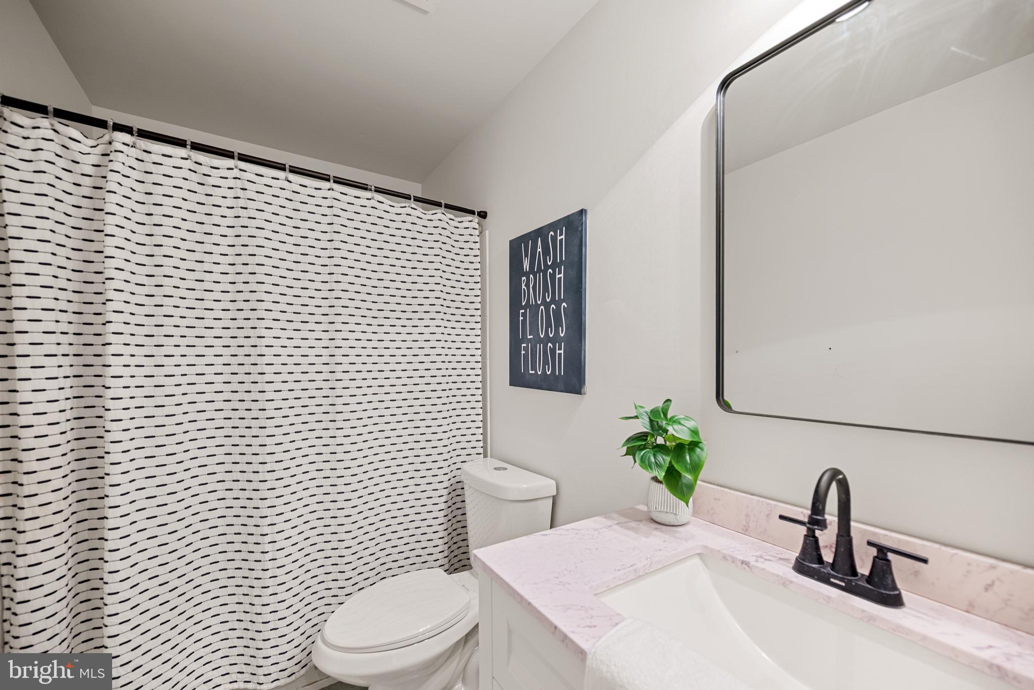 7838 Roundabout Way Springfield, VA 22153 - Photo 28 of 56 a bathroom with a toilet sink and mirror