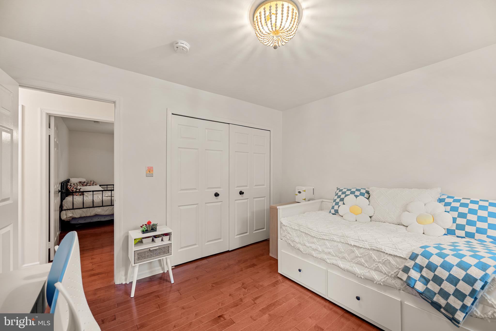 7838 Roundabout Way Springfield, VA 22153 - Photo 30 of 56 a room with a bed and wooden floor