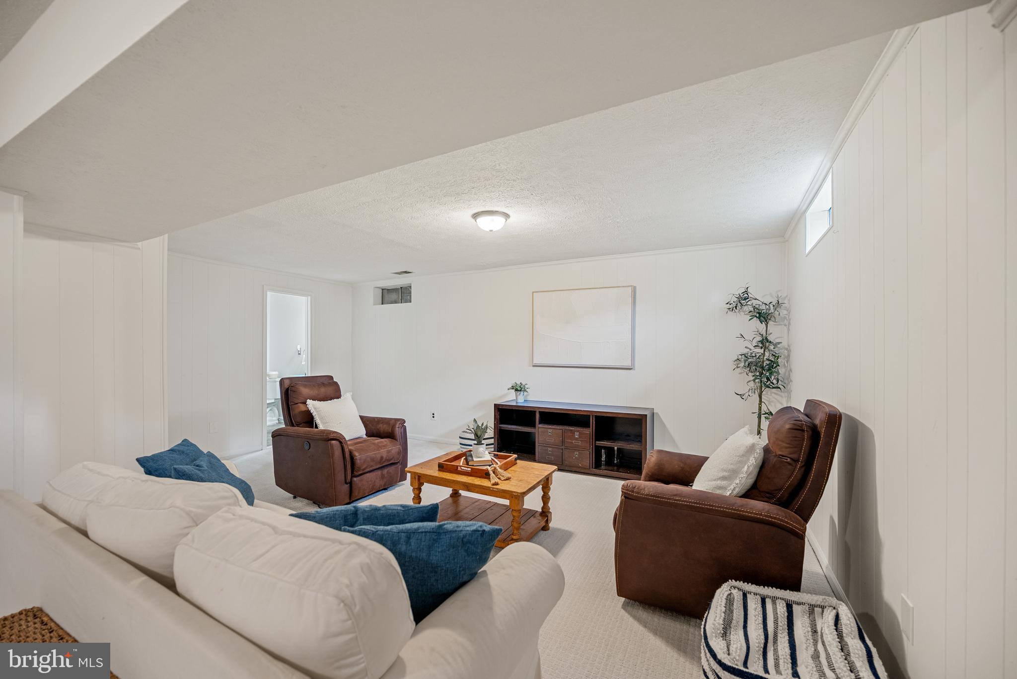 7838 Roundabout Way Springfield, VA 22153 - Photo 34 of 56 a living room with furniture a fireplace and a potted plant